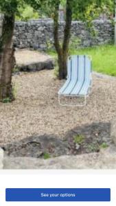a blue bench sitting on the ground in a park at Lakeside in Carrowmoreknock