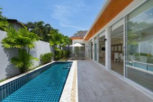 an external view of a villa with a swimming pool at 5 Minutes to Naiharn Beach, Private, Quiet and Cozy in Nai Harn Beach