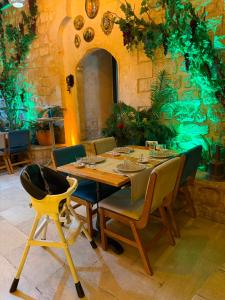 a wooden table and chairs in a room at Maridin Hotel in Mardin