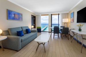 a living room with a couch and a table at Wyndham Deerfield Beach Resort in Deerfield Beach