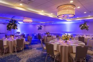 a banquet room with tables and chairs and purple lighting at Wyndham Deerfield Beach Resort in Deerfield Beach +63 photos