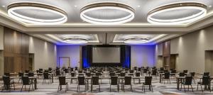 a conference room with tables and chairs and a screen at Hyatt Regency Bloomington - Minneapolis in Bloomington +79 photos