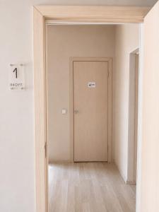 an empty hallway with a door in a room at Terra Hotel in Berezovka