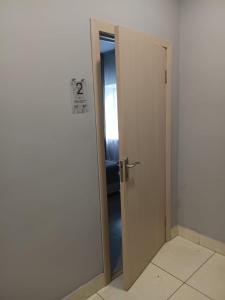 an open door in a room with a sign on it at Terra Hotel in Berezovka