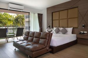 a bedroom with a bed and a couch and a balcony at The BELL in Nai Yang Beach +34 photos