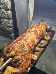 a cooked turkey is cooking on a grill at Ранч ДИМ in Ivanjica +4 photos