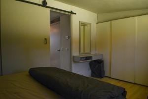 an empty room with a bed and a mirror at Atelier Markelo in Markelo