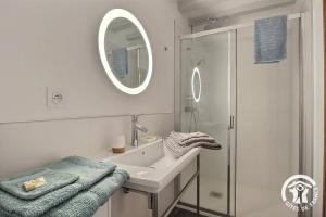 a white bathroom with a sink and a shower at La tour carrée in Trimer +16 photos