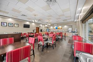 a dining room with tables and red chairs at Comfort Suites Near Gettysburg Battlefield Visitor Center in Gettysburg