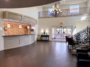 a large room with a lobby with a chandelier at Comfort Suites Galveston Cruise Port Area - Beachside in Galveston +43 photos