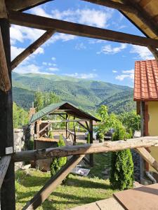 a wooden fence with a view of the mountains at LerHouseDilijan in Dilijan