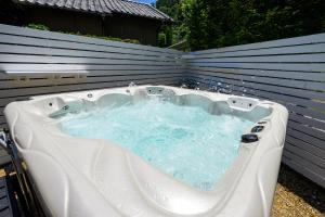 a jacuzzi bathtub in a backyard at Aoshima Surfers House in Miyazaki