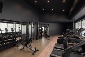 a gym with treadmills and machines in a room at Hyatt Regency Niagara Falls Fallsview in Niagara Falls