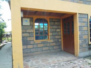 a brick house with a door and a window at WANDA's in Makandara
