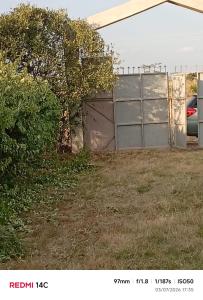 a yard with a fence and a building at WANDA's in Makandara