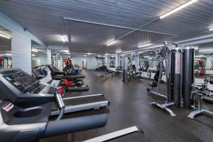 a gym with several treadmills and cardio machines at Crestwood Hotel in Hinton