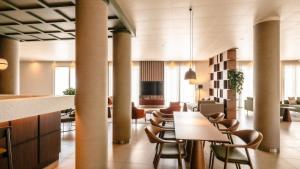 a lobby with tables and chairs in a building at Hotel Fiera Rimini in Rimini
