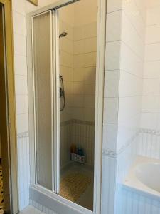 a shower with a glass door next to a sink at Big Brother Bed & Rooms in Treviso +34 photos