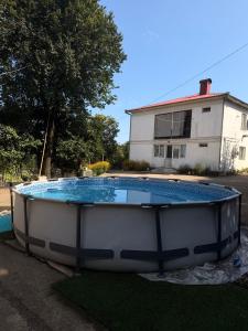 a large swimming pool in the yard of a house at Гостевой дом у Эмзара in Batumi
