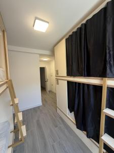 a room with black curtains and a room with wooden floors at Albergue -Hostel ManuelaINN in El Burgo de Osma +14 photos