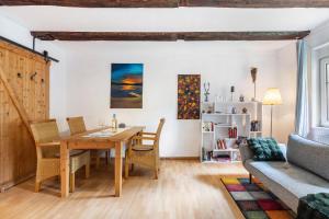 a living room with a dining room table and a couch at Fuchsrevier Fox District Apartment in Erkerode