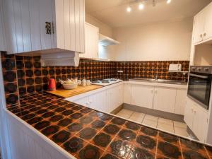 a kitchen with white cabinets and a counter top at ALRA2 Accommodations in Brisbane