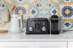 a kitchen counter with a toaster and other appliances at Tia Maria - Tradizione e Autenticità in Ploaghe