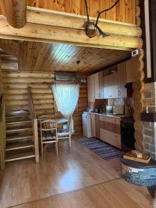 a kitchen with a table and chairs in a cabin at Outbreak 3 bedroom house with outdoor pool, BBQ and dining in Pirita in Corjova