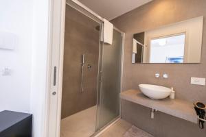 a bathroom with a sink and a glass shower at Tenuta Rapillo in Castellammare del Golfo +69 photos