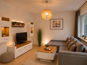 a living room with a couch and a tv at Moscow Areal Suite in Baden-Baden
