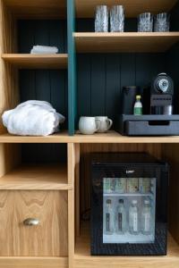 a wooden shelf with a bottle of water in it at Bernwood Park Hotel in Boarstall