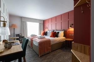 a hotel room with a bed and a desk at Bernwood Park Hotel in Boarstall