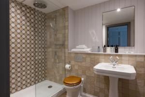 a bathroom with a sink and a toilet and a shower at Bernwood Park Hotel in Boarstall +46 photos