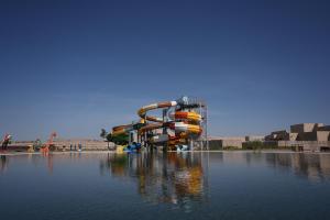 a water park with a water slide in the water at Arda Angariki in Khiva