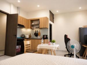 a kitchen and dining room with a table and chairs at The F House in Danang