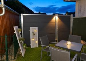 a backyard with a table and chairs and a fence at Gästehaus Sibylle in Rust