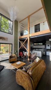 a large living room with a couch and chairs at COTTAGES ANTOINETTE in Chigny-les-Roses