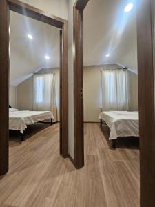 a room with two beds and a mirror at George House in Batumi +55 photos