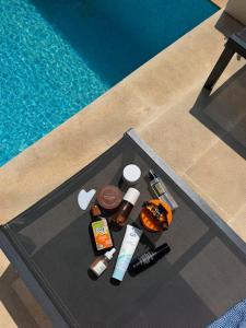 a table with cosmetics on it next to a pool at Via Lattea Lb in Batroûn