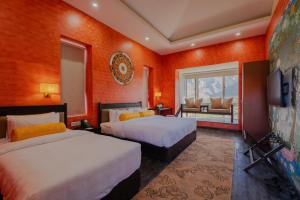 a hotel room with two beds and a television at Lo Mustang Himalayan Resort in Muktināth