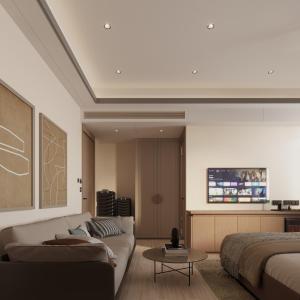 a living room with a couch and a bed at Ananta Elite in Somnath
