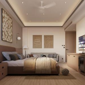 a bedroom with a large bed and a tv at Ananta Elite in Somnath