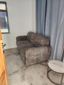 a living room with a couch and a table at Blue Dhow Villas in Paje