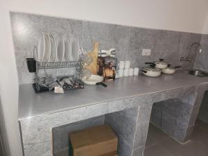 a counter top with a bunch of kitchen utensils at Blue Dhow Villas in Paje