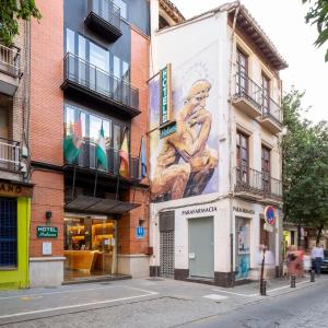 a building with a large mural on the side of it at Hotel Molinos in Granada