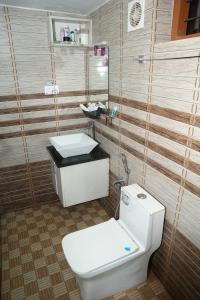 a bathroom with a toilet and a sink at Kaivalyam Homestay in Wayanad +101 photos