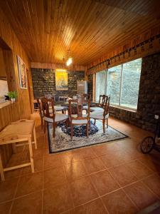 a dining room with a table and chairs at Haven Hilltop Cottage, Dunga Gali in Dunga Gali