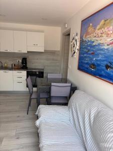 a bedroom with a bed and a table and a kitchen at Dal barone in Capo dʼOrlando