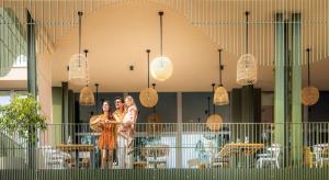 two women standing in front of a building with lights at Sunny Porec by Valamar in Poreč