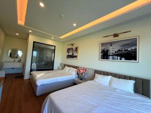 a hotel room with two beds and a mirror at Huong Sky Co To in Chung Cap +17 photos